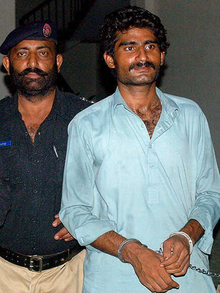 Wasim (R), the brother of slain social media celebrity Qandeel Baloch, is escorted by police following his arrest for Qandeel's death in Multan early on July 17, 2016. A Pakistani social media celebrity whose selfies polarised the deeply conservative Muslim country has been murdered by her brother in a suspected honour killing, officials said July 16, prompting shock and revulsion. / AFP / SS MIRZA (Photo credit should read SS MIRZA/AFP/Getty Images)