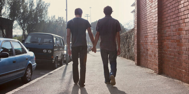 Gay male couple holding hands